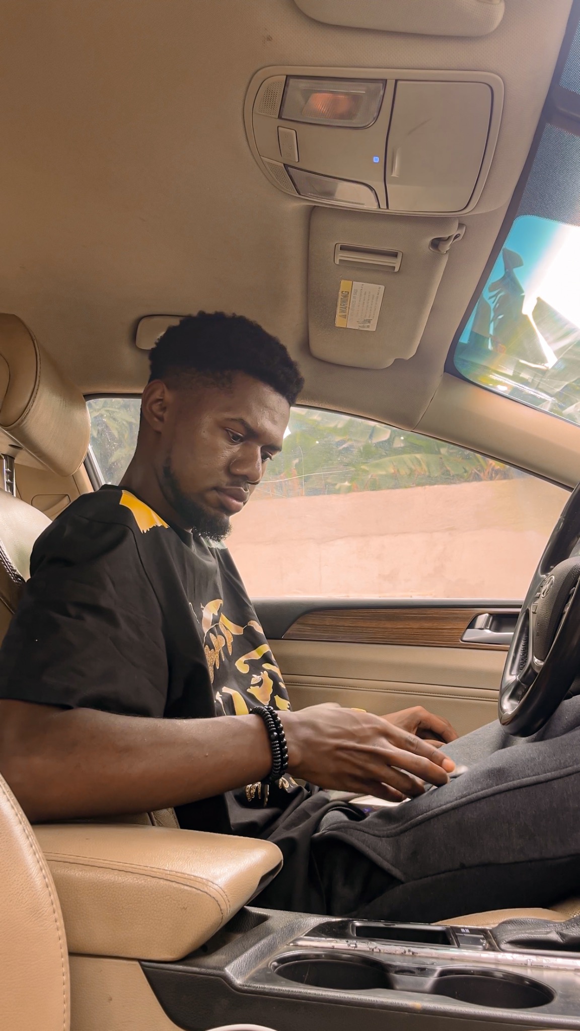 Dace Boateng sitting in a car